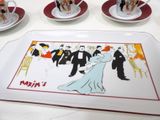 a plate with a picture of a wedding party on it