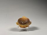 small glass figurine of a snail with a shell on a clear base