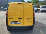a yellow van that is parked in a parking lot