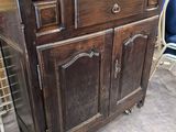 a wooden cabinet with a mirror on top of it