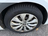 a close up of a car ' s tire on the pavement