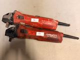 two red tools sitting on top of a table next to each other