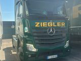 two trucks that are parked next to each other