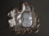 a silver plate with a picture of a man and a woman on it