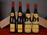 four bottles of wine are lined up on a table