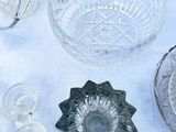 many different glass dishes and bowls on a table