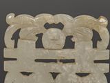 a white jade plaque with two birds on it
