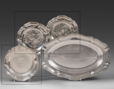 three silver trays and two silver dishes on a table