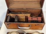 two clocks in a wooden box on a table