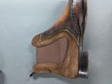 a pair of brown boots hanging on a wall