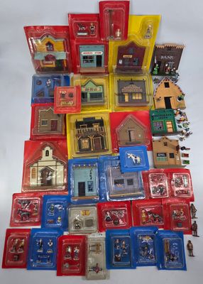 a lot of different types of miniature buildings on the table