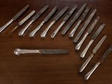 a lot of knives that are sitting on a table