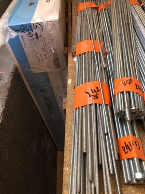 many different sizes and sizes of steel rods on the counter