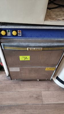 an image of a stainless steel dishwasher sitting on top of a hard wood floor