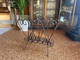 a wrought iron chair in the middle of a living room