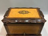 an old wooden box with a decorative design on it