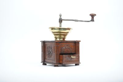 a coffee grinder sitting on top of a wooden table