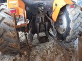 a tractor that is sitting in the dirt