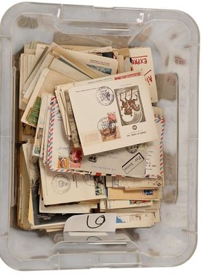 a plastic container filled with lots of stamps and postcards