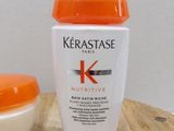 a bottle of kerastase and a bowl of cream on a table