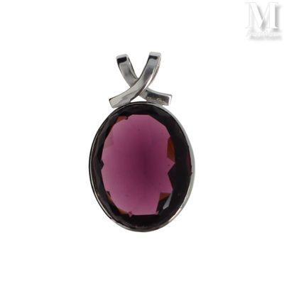 a close up of a pendant with a purple stone in it
