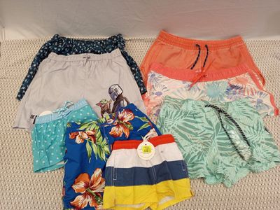 several pairs of shorts are laid out on the floor