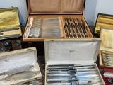 a lot of silverware in a case on a table