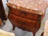 a table with a marble top and a chair in a room