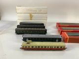 several toy trains are lined up on a white surface