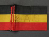 a close up of a red, yellow and black striped belt