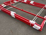 a red frame that is sitting in the middle of a parking lot