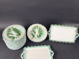 four pieces of green and white dishes and trays on a table