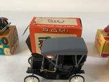 two toy cars and a box of boxes on a white surface