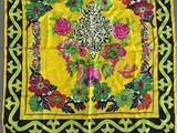 an image of a yellow and black square scarf with flowers and leaves on it