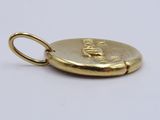 a close up of a gold coin on a white surface