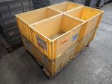 a large yellow crate sitting on the ground next to other crates
