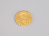 an image of a close up of a gold coin on a white surface