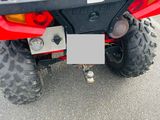 a red four - wheeler with a black seat on the back of it