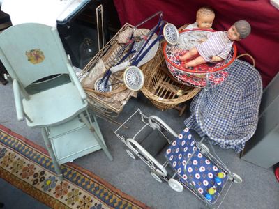 une poupée dans un panier posé à côté d'une chaise et d'autres objets