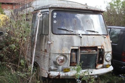 an old van that is sitting in the grass