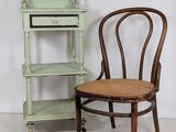 a chair and a shelf in the corner of a room