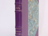 a purple book sitting on top of a white table