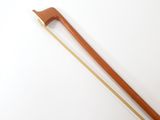 an old wooden stick with a wooden handle on a white surface
