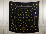 a black and yellow scarf hanging on a wall