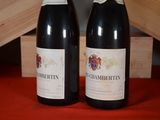 two bottles of wine sitting next to each other on a table