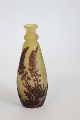 a yellow vase with a brown design on it