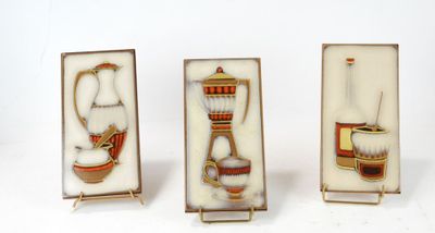 four pieces of glass with different designs on them on a white surface