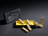 a small box with wooden blocks in it on a black surface
