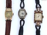 three different types of watches are displayed on a white surface
