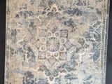 an antique rug with a floral design on a black background